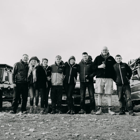 Black and white photo of the Direct4x4 team at an outdoor motor show.