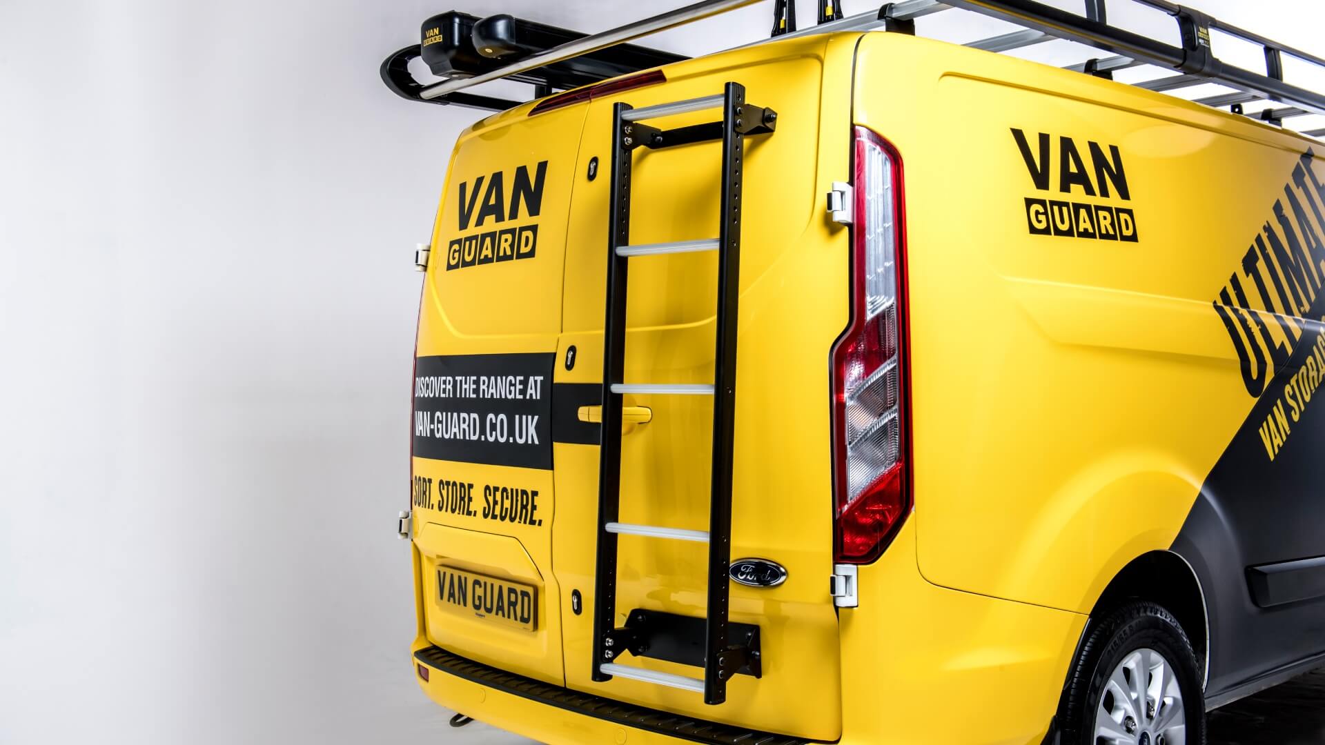 Yellow van with Van Guard ladder rack on a white background
