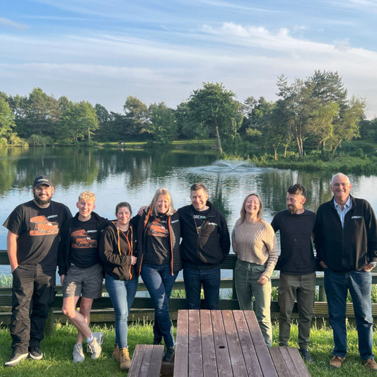 Photo of the Direct4x4 team at a beer garden in front of a Derbyshire lake.