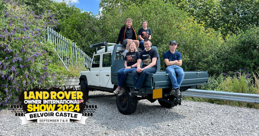 Photo of the Direct4x4 team on a Land Rover Defender pickup truck.