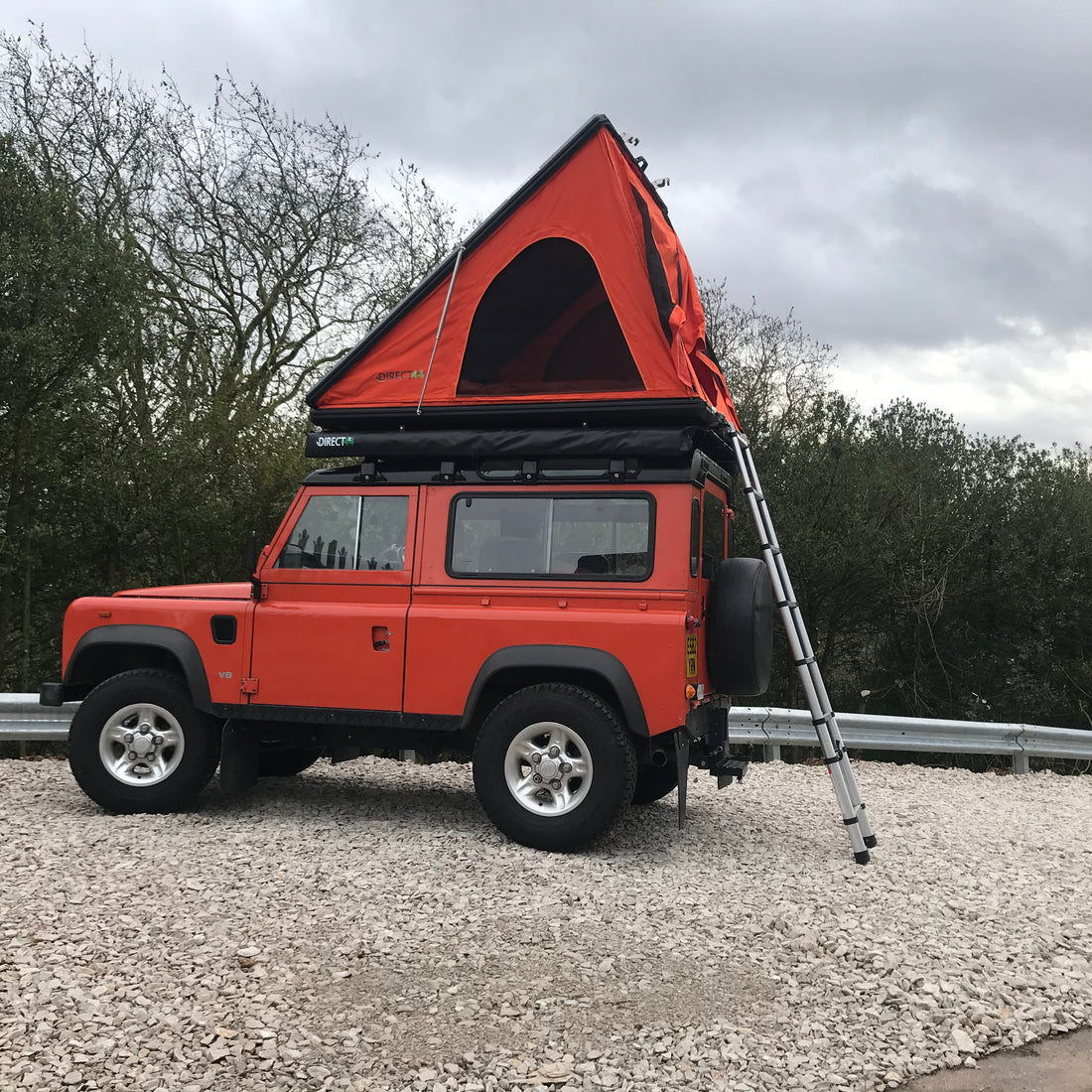 Direct4x4 Adventurer 2 person roof top camping tent in orange on an orange Land Rover Defender 90