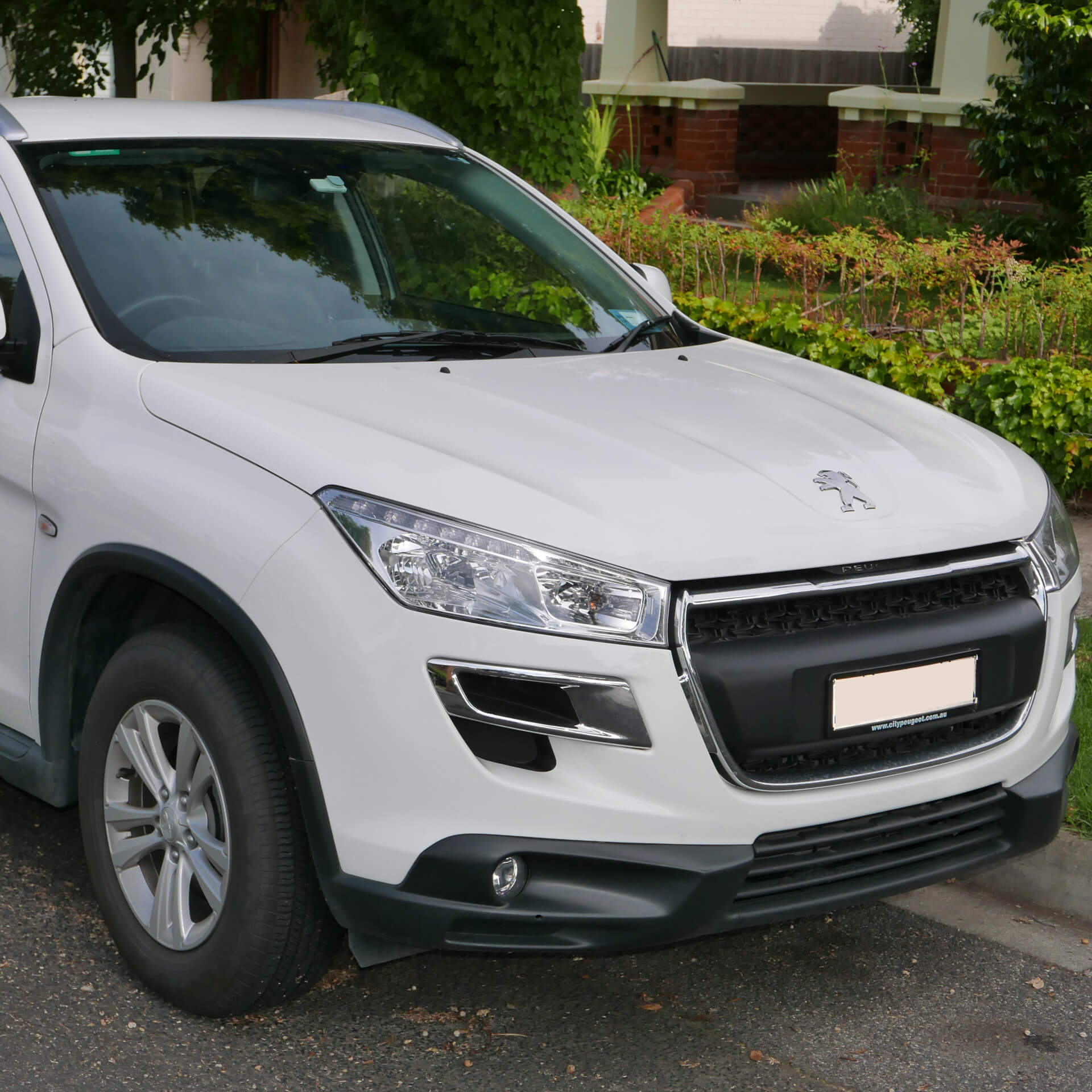 Direct4x4 accessories for Peugeot 4008 vehicles with a photo of the front of a white Peugeot 4008 parked by a kerb