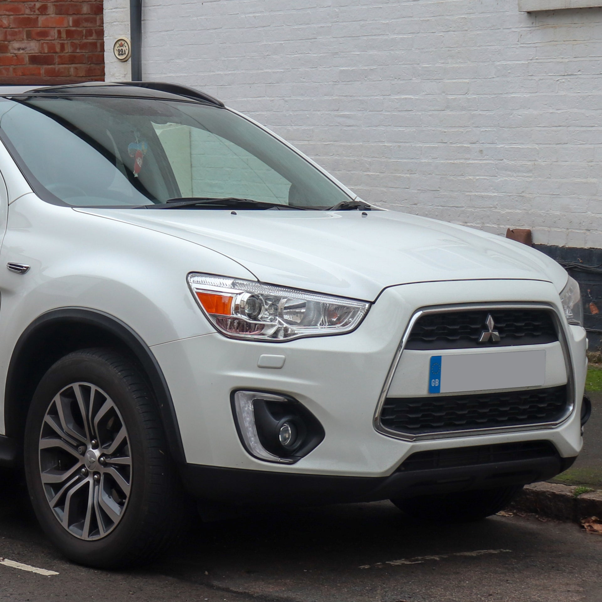 Direct4x4 accessories for Mitsubishi ASX vehicles with a photo of the front of a white Mitsubishi ASX parked next to a kerb