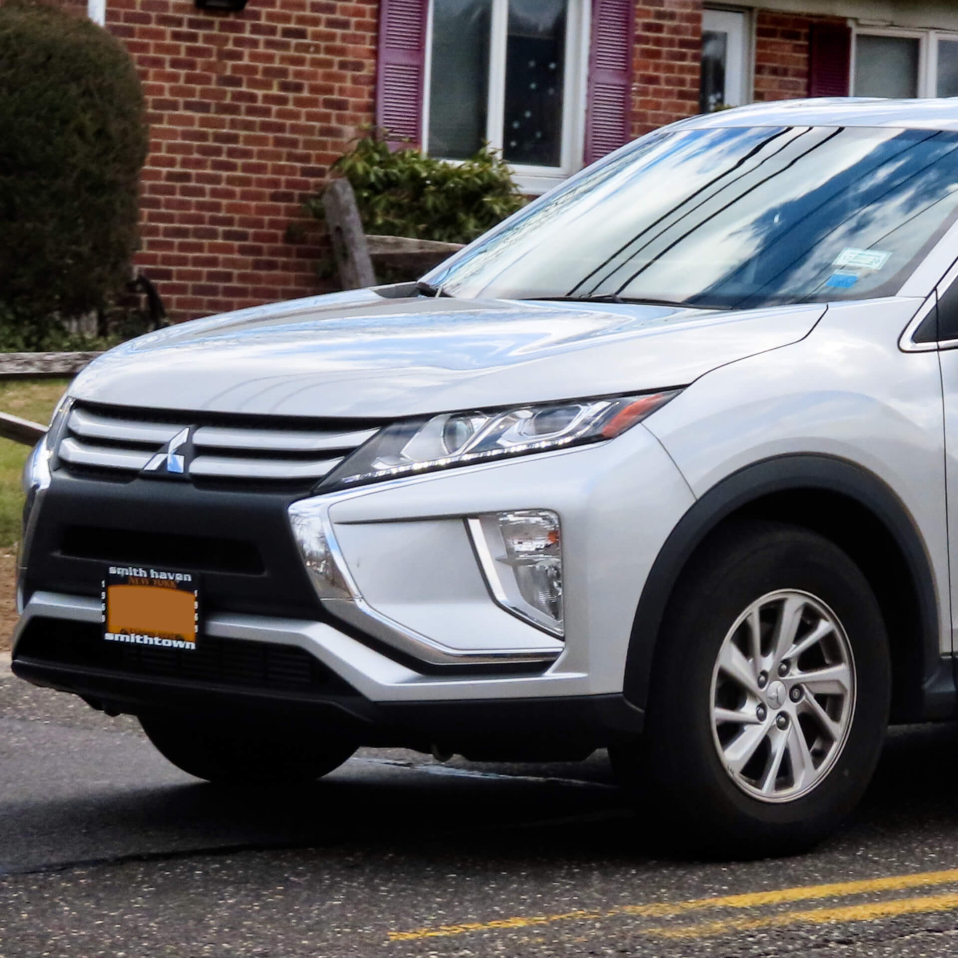 Direct4x4 accessories for Mitsubishi Eclipse Cross vehicles with a photo of the front of a silver Mitsubishi Eclipse Cross parked outside a house