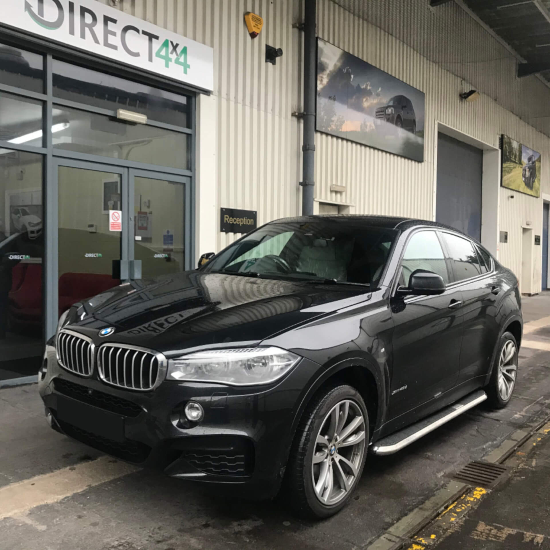 Direct4x4 accessories for BMW X6 vehicles with a photo of high flyer side steps fitted to a BMW X6 outside our depot