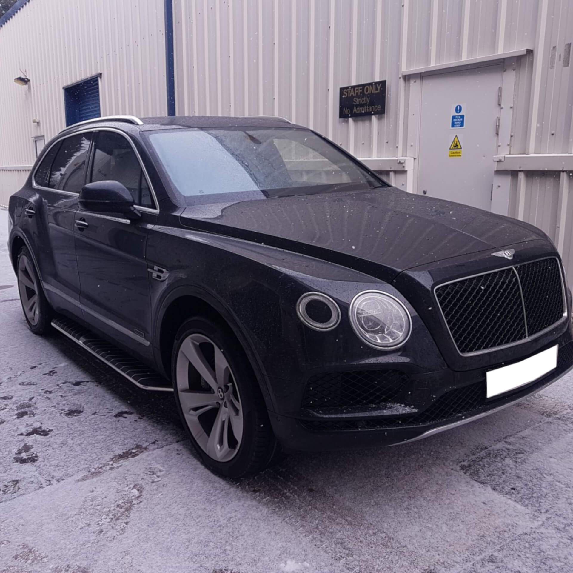 Direct4x4 luxury accessories for Bentley Bentayga vehicles with a photo of a black Bentley Bentayga in the snow at our depot