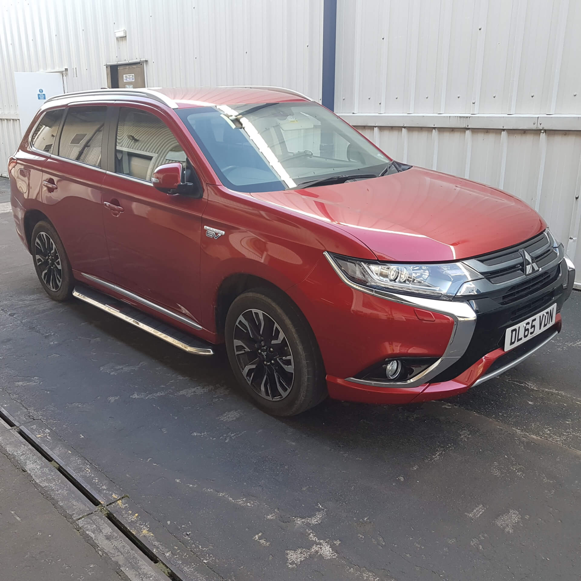 Direct4x4 accessories for Mitsubishi Outlander vehicles with a photo of a red Mitsubishi Outlander outside our offices fitted with High Flyer style side steps