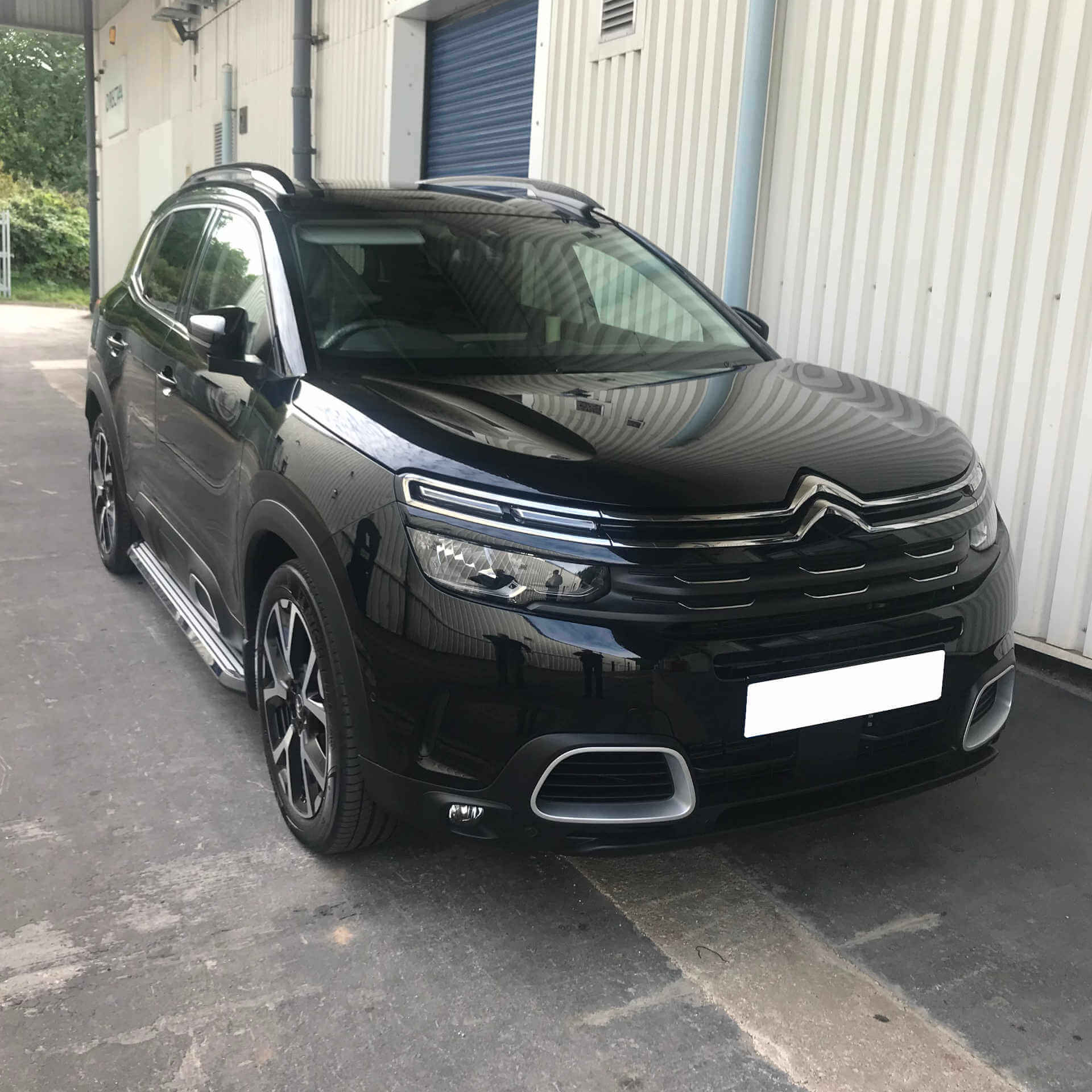 Direct4x4 accessories for Citroen C5 Aircross vehicles with a photo of a black Citroen C5 Aircross fitted with out Stingray steps outside our depot