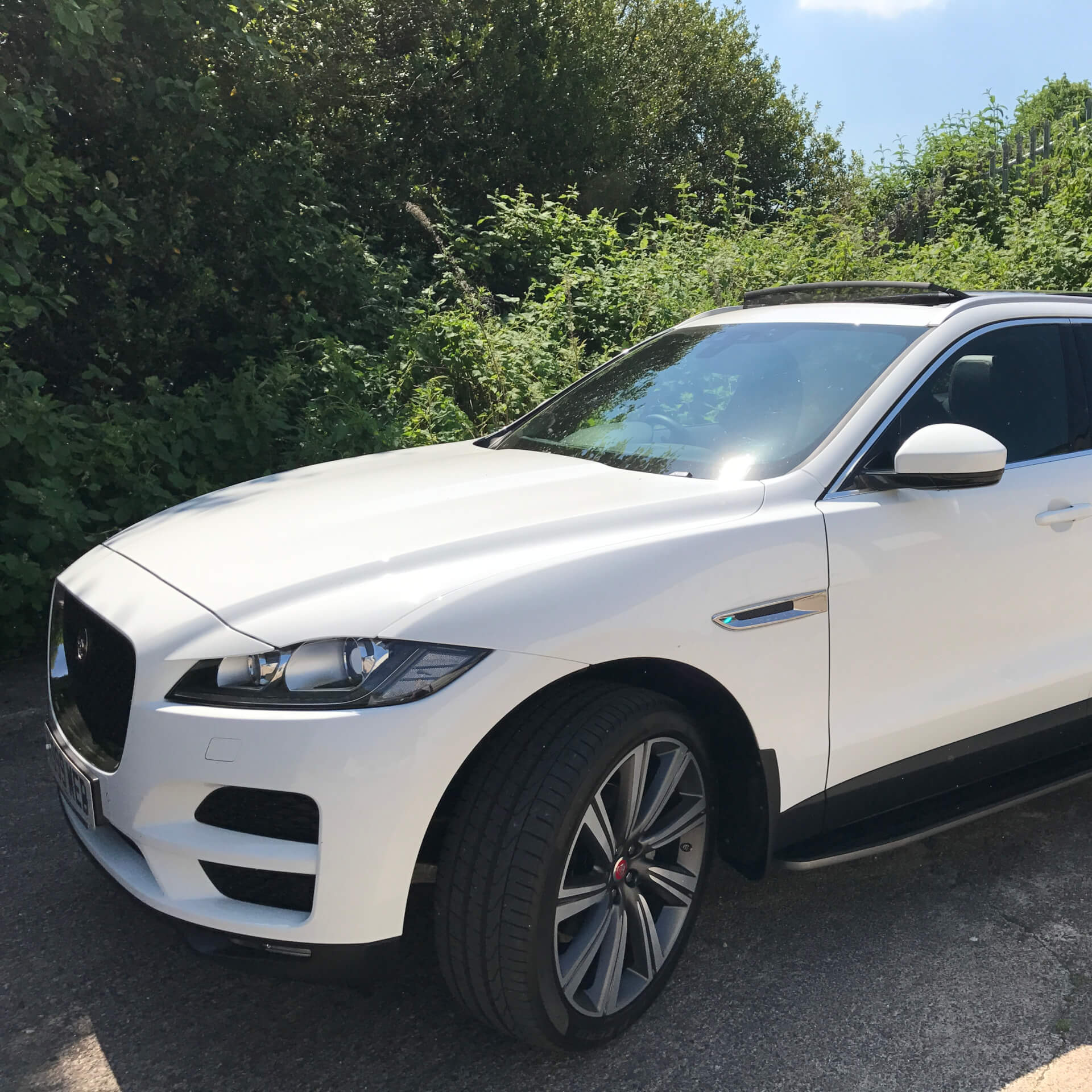 Direct4x4 accessories for Jaguar F-Pace vehicles with a photo of a white Jaguar F-Pace parked in front of greenery in the sunshine