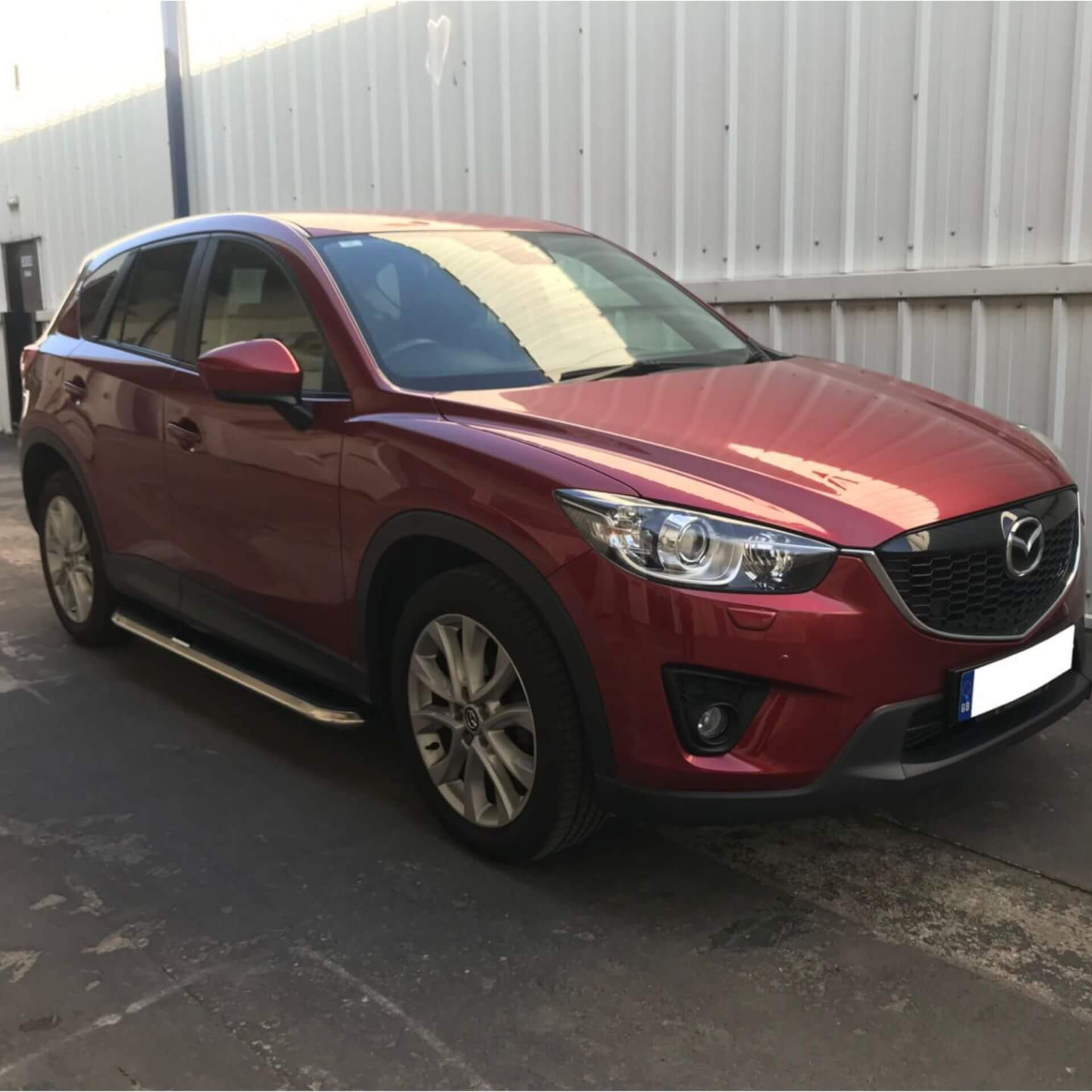 Direct4x4 accessories for Mazda CX-5 vehicles with a photo of a cherry red Mazda CX-5 at our offices fitted with High Flyer side steps