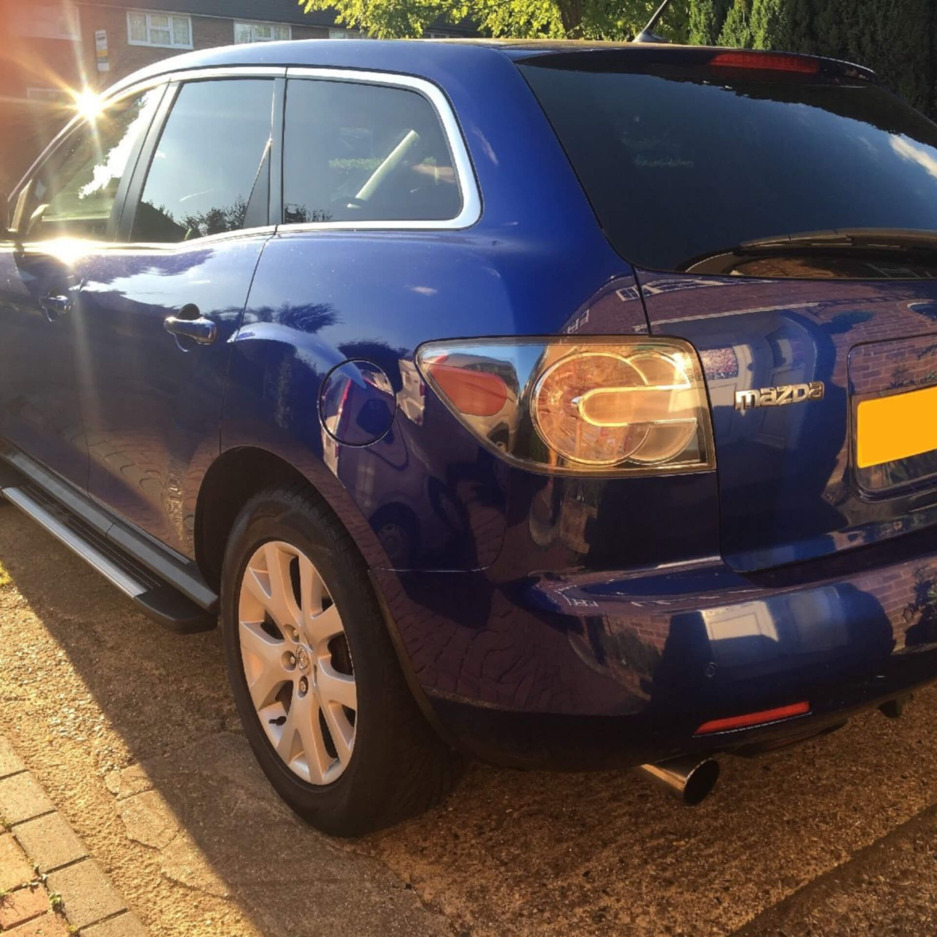 Direct4x4 accessories for Mazda CX-7 vehicles with a photo of a blue Mazda CX-7 parked on a driveway in the sun
