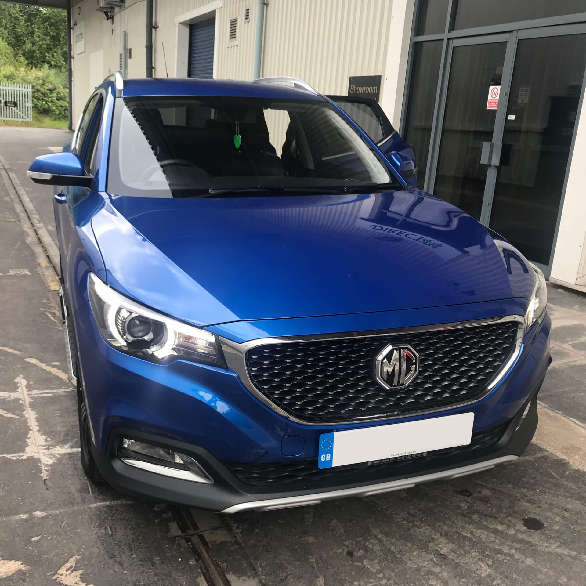 Direct4x4 accessories for MG ZS vehicles with a photo of a bright blue MG ZS parked outside our reception