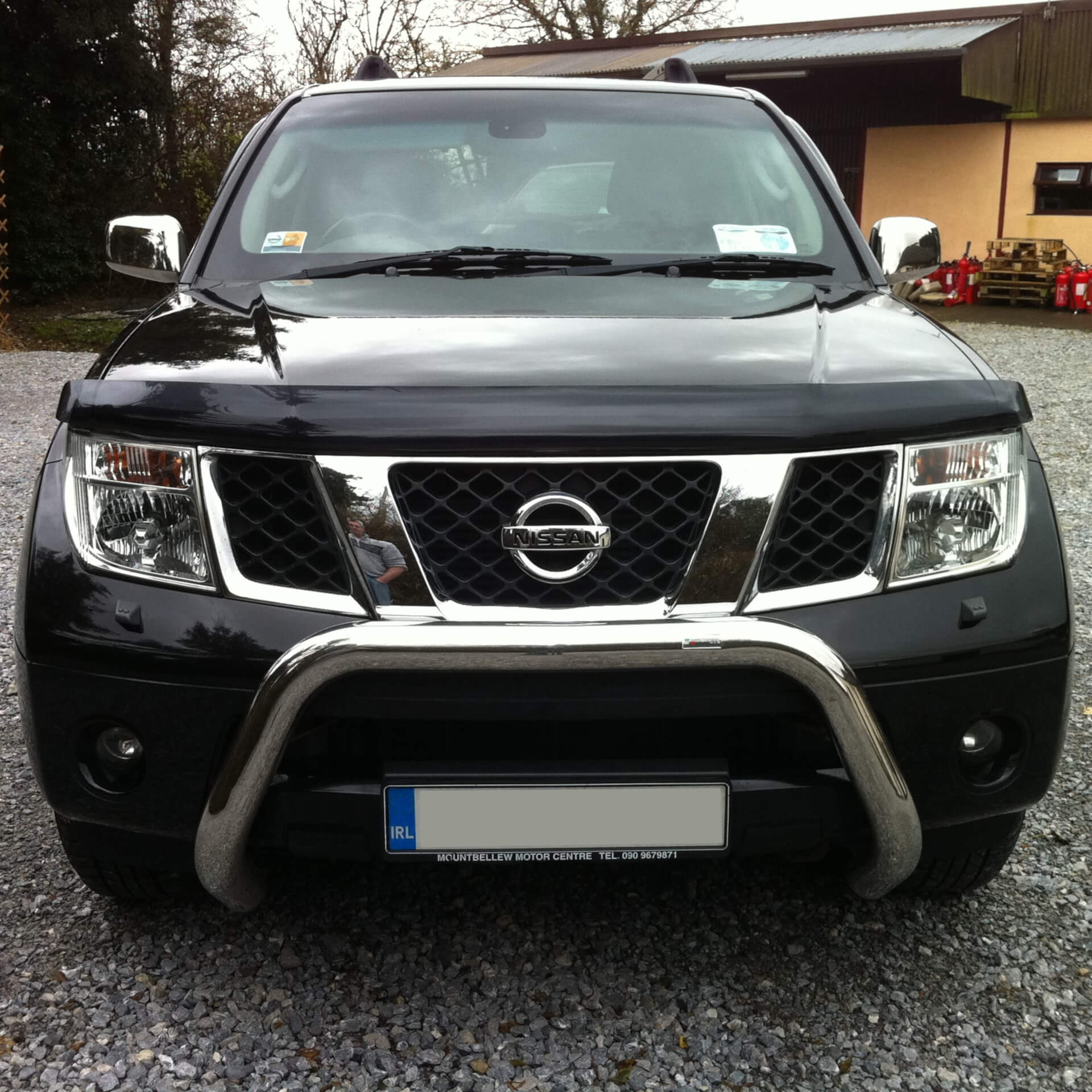 Direct4x4 accessories for Nissan Pathfinder vehicles with a photo of the front of a Nissan Pathfinder parked on gravel
