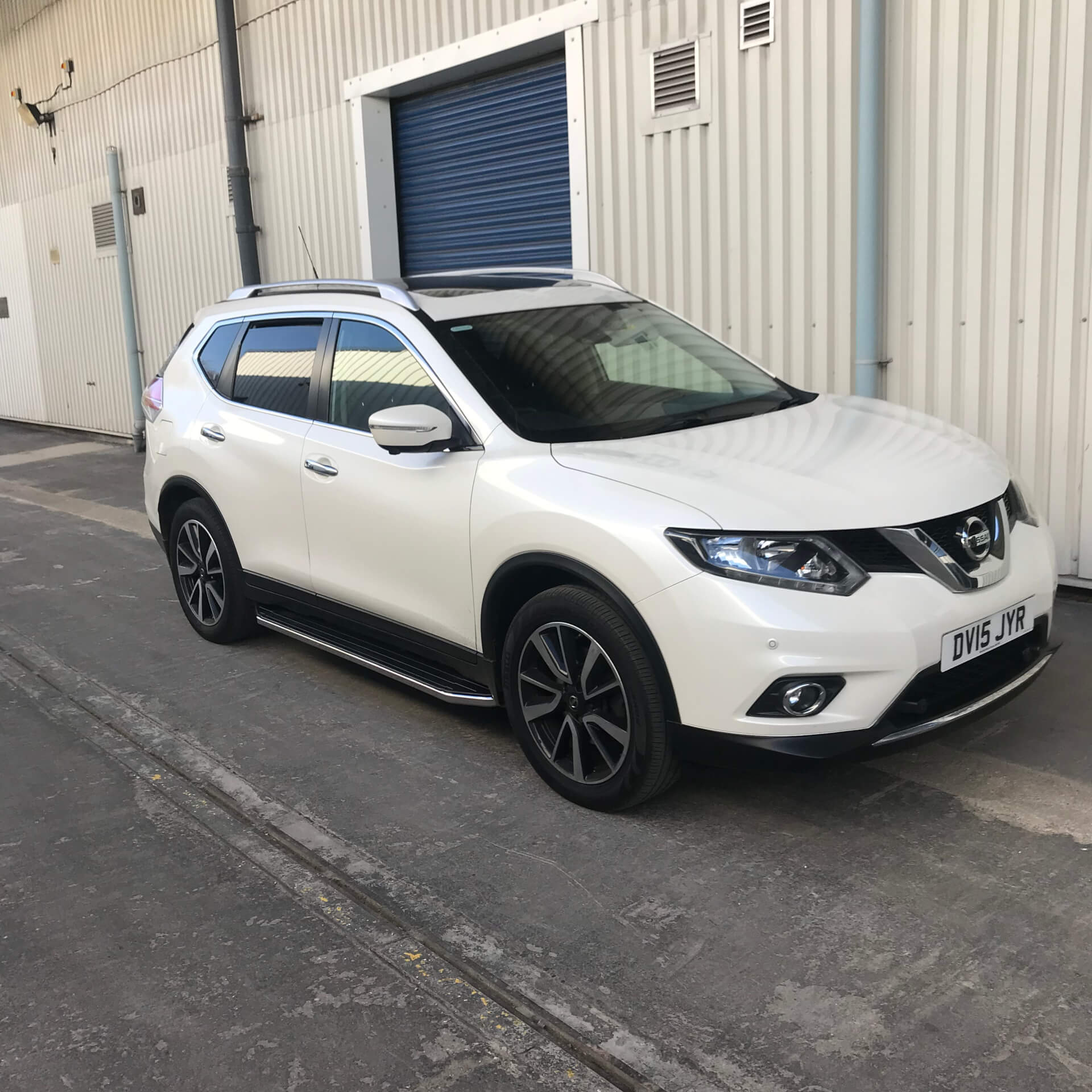 Direct4x4 accessories for Nissan X-Trail vehicles with a photo of a white Nissan X-Trail parked outside our depot fitted with raptor style side steps