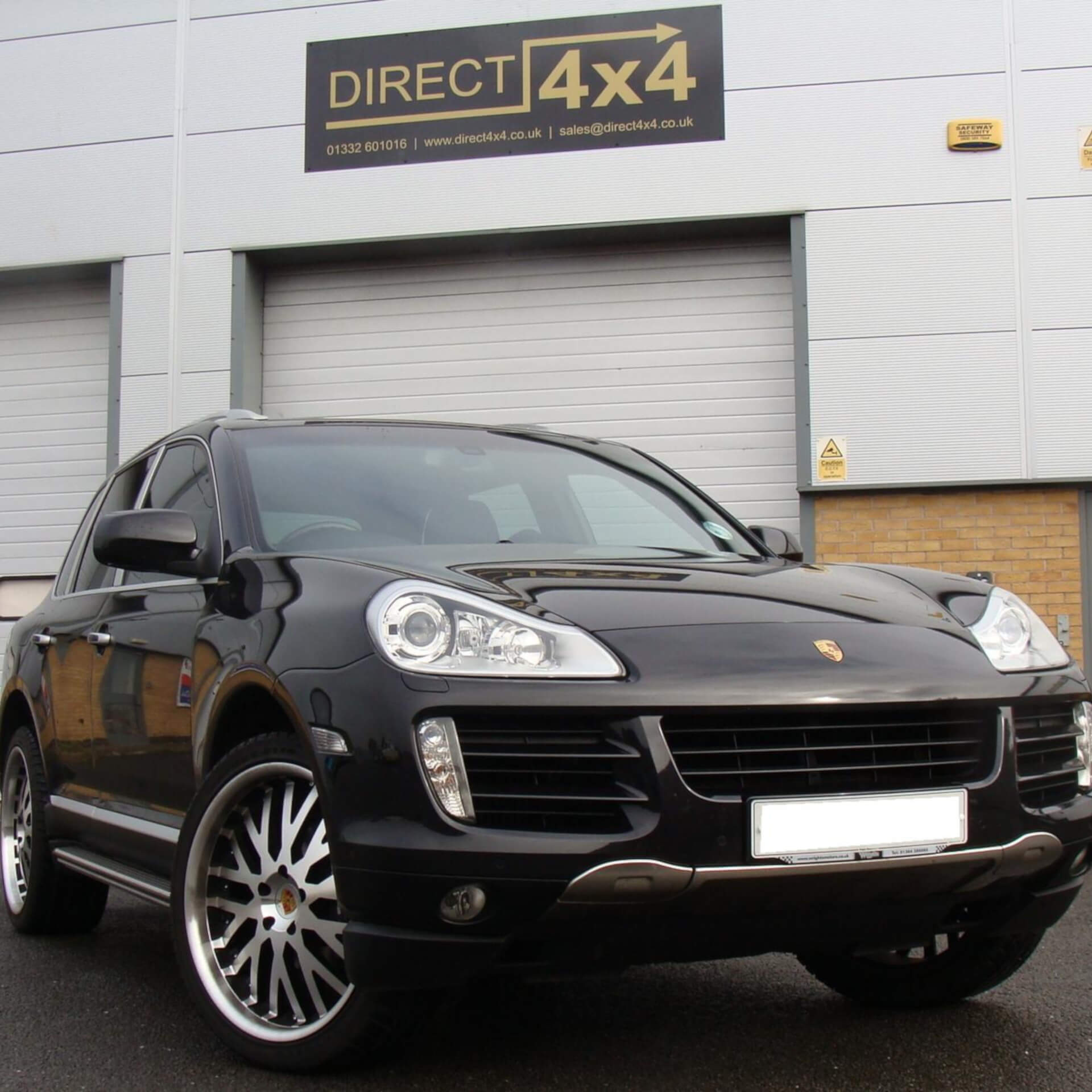 Direct4x4 accessories for Porsche Cayenne vehicles with a photo of a black Porsche Cayenne parked outside our offices