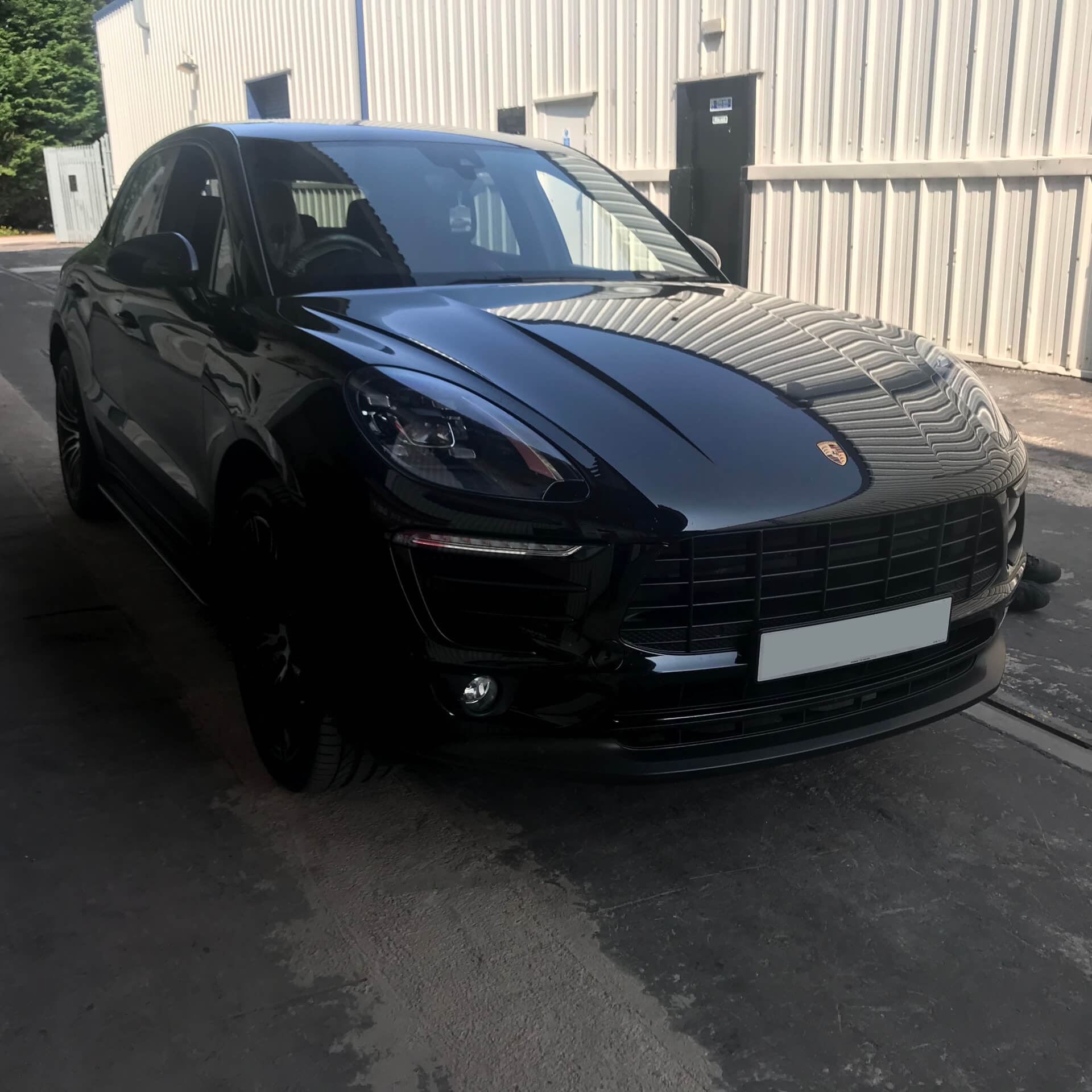 Direct4x4 accessories for Porsche Macan vehicles with a photo of a black Porsche Macan parked outside our offices