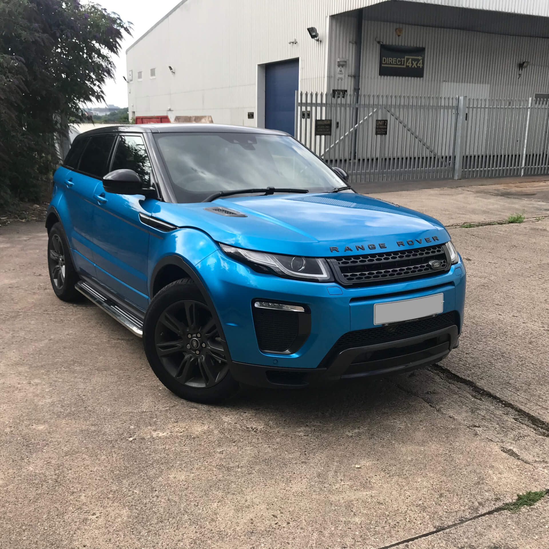 Direct4x4 accessories for Range Rover Evoque vehicles with a photo of a bright blue Range Rover Evoque outside our offices fitted with premier side steps