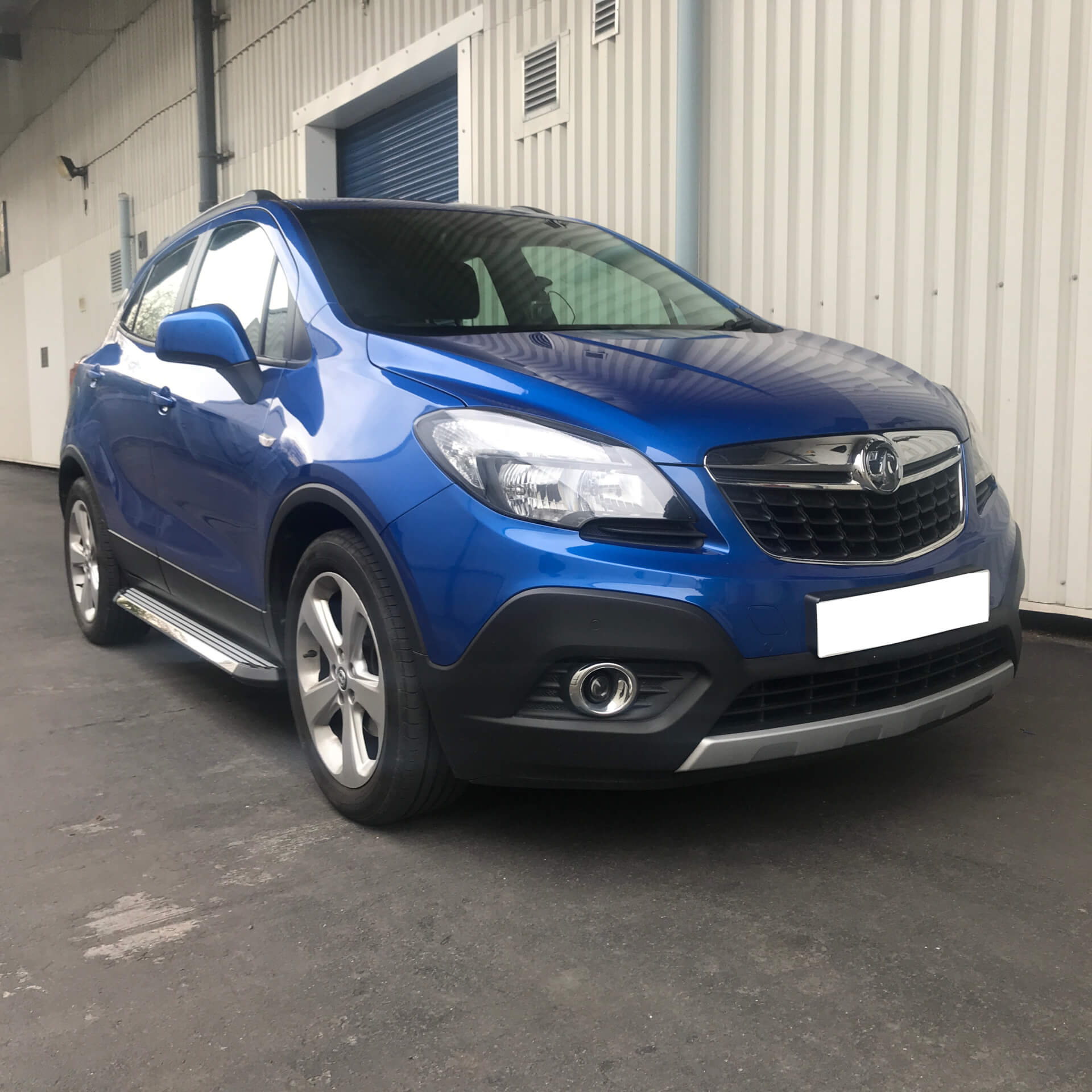 Direct4x4 accessories for Vauxhall Mokka vehicles with a photo of a blue Vauxhall Mokka parked outside our depot fitted with side steps