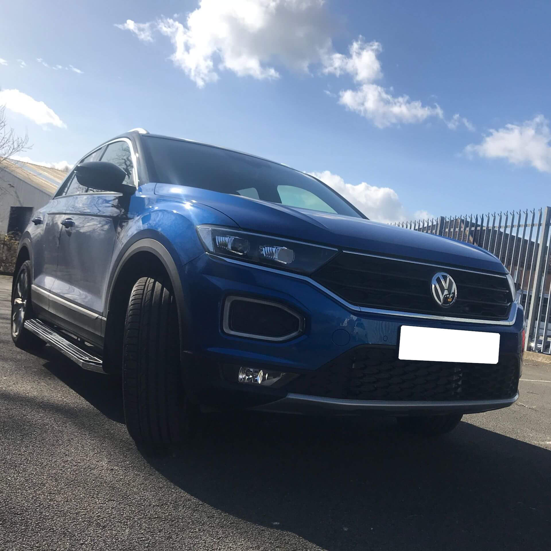 Direct4x4 accessories for Volkswagen T-Roc vehicles with a photo of a blue Volkswagen T-Roc under a blue and white sky