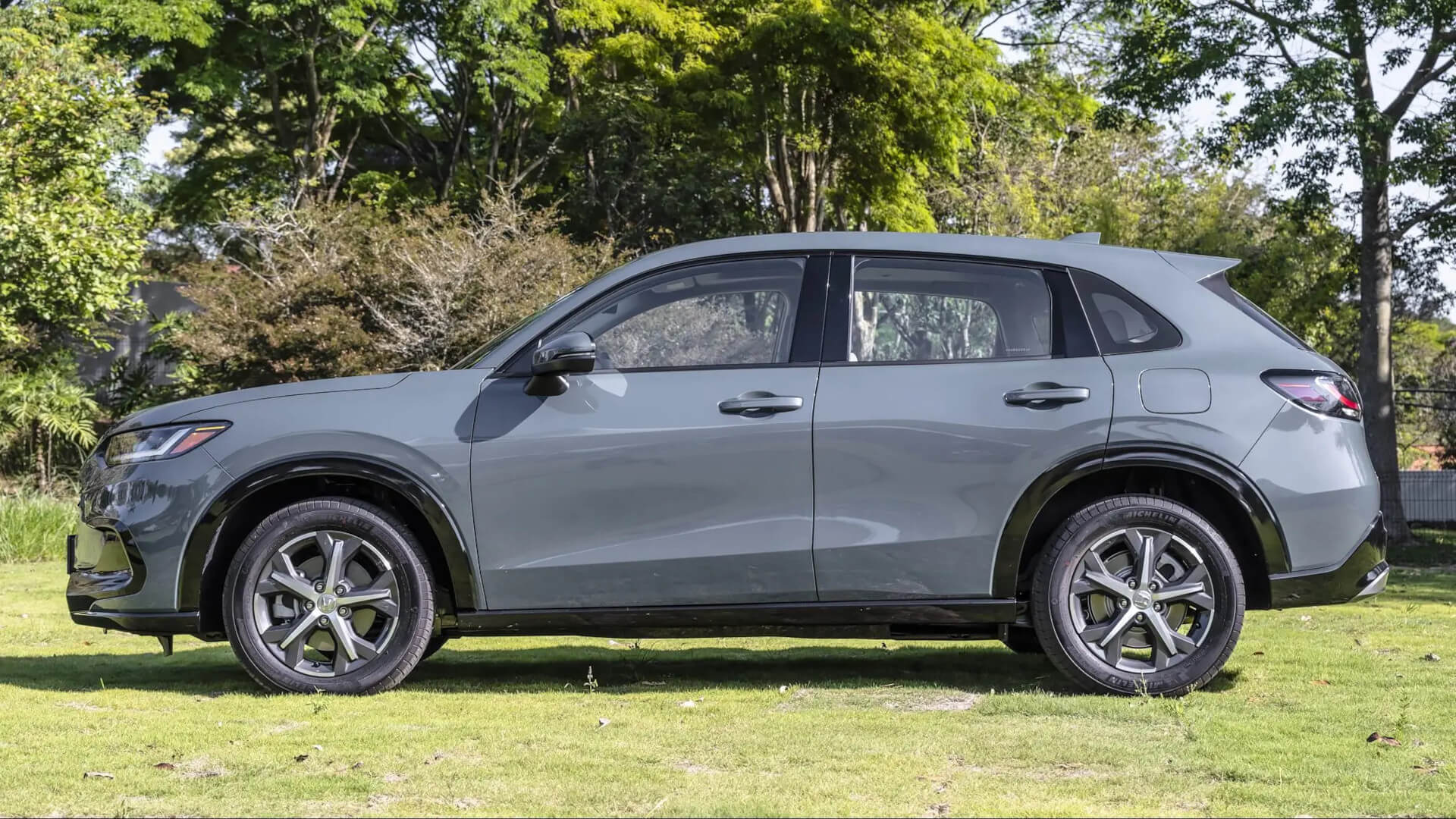 Direct4x4 side steps running boards for the Honda ZR-V hybrid vehicle parked in a field.