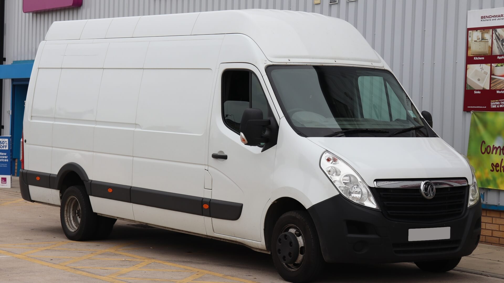 Photo of a large white Vauxhall Opel Movan work van parked in front of an industrial unit