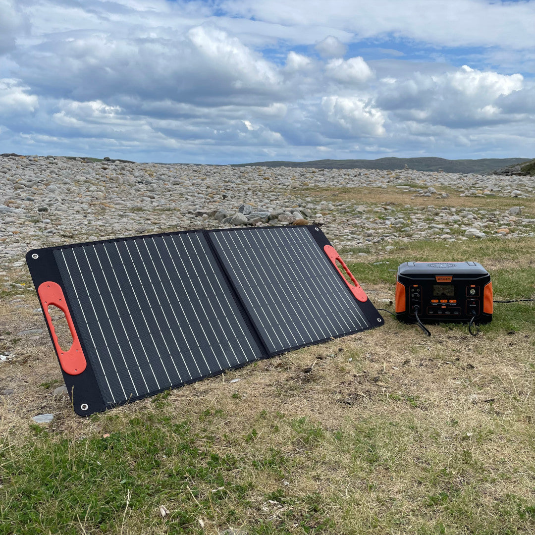 Photo of a Direct4x4 portable power charging station and solar panel in a large field in Scotland.
