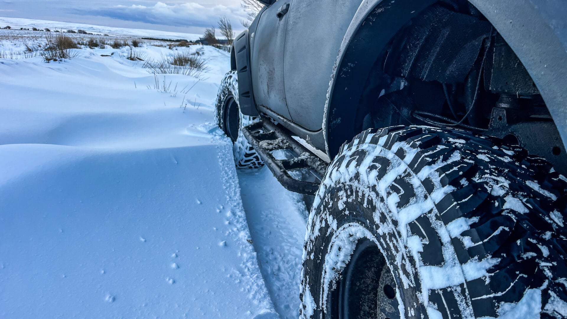 Photo of a Mitsubishi L200 pickup truck vehicle parked in deep snow